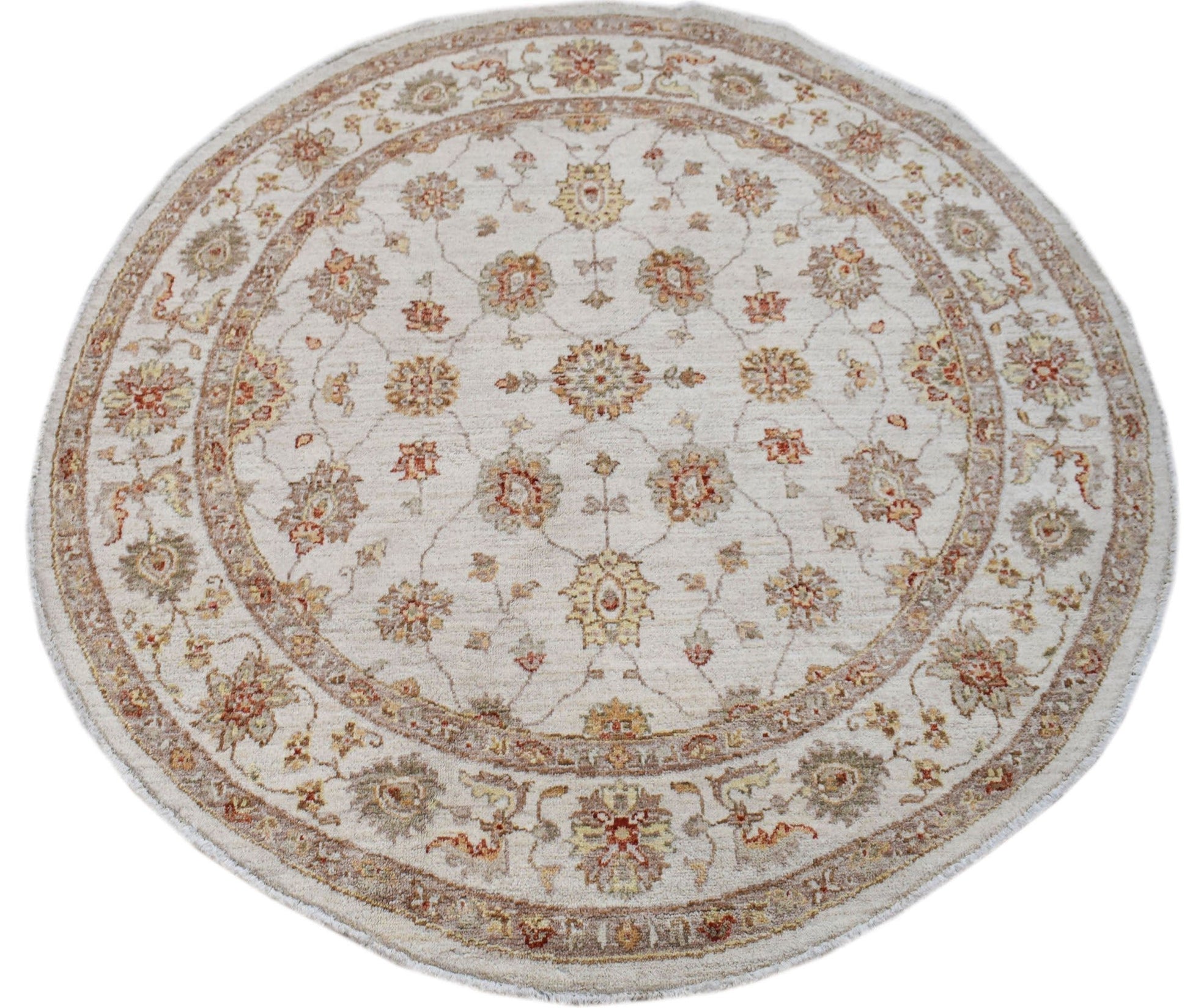 A round Afghan Chobi rug featuring a traditional floral pattern in earthy tones on a cream base.