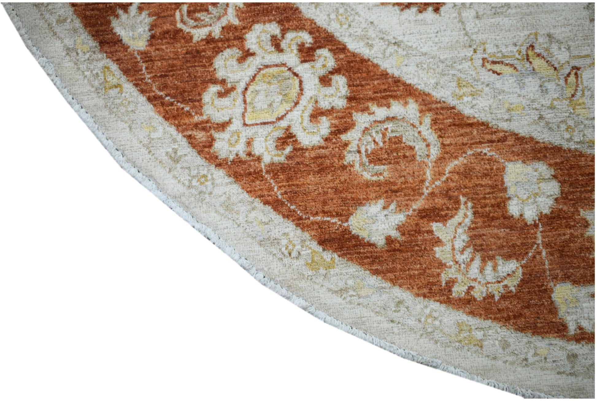 A round Afghan Chobi rug featuring a traditional floral pattern in rust orange and cream tones.