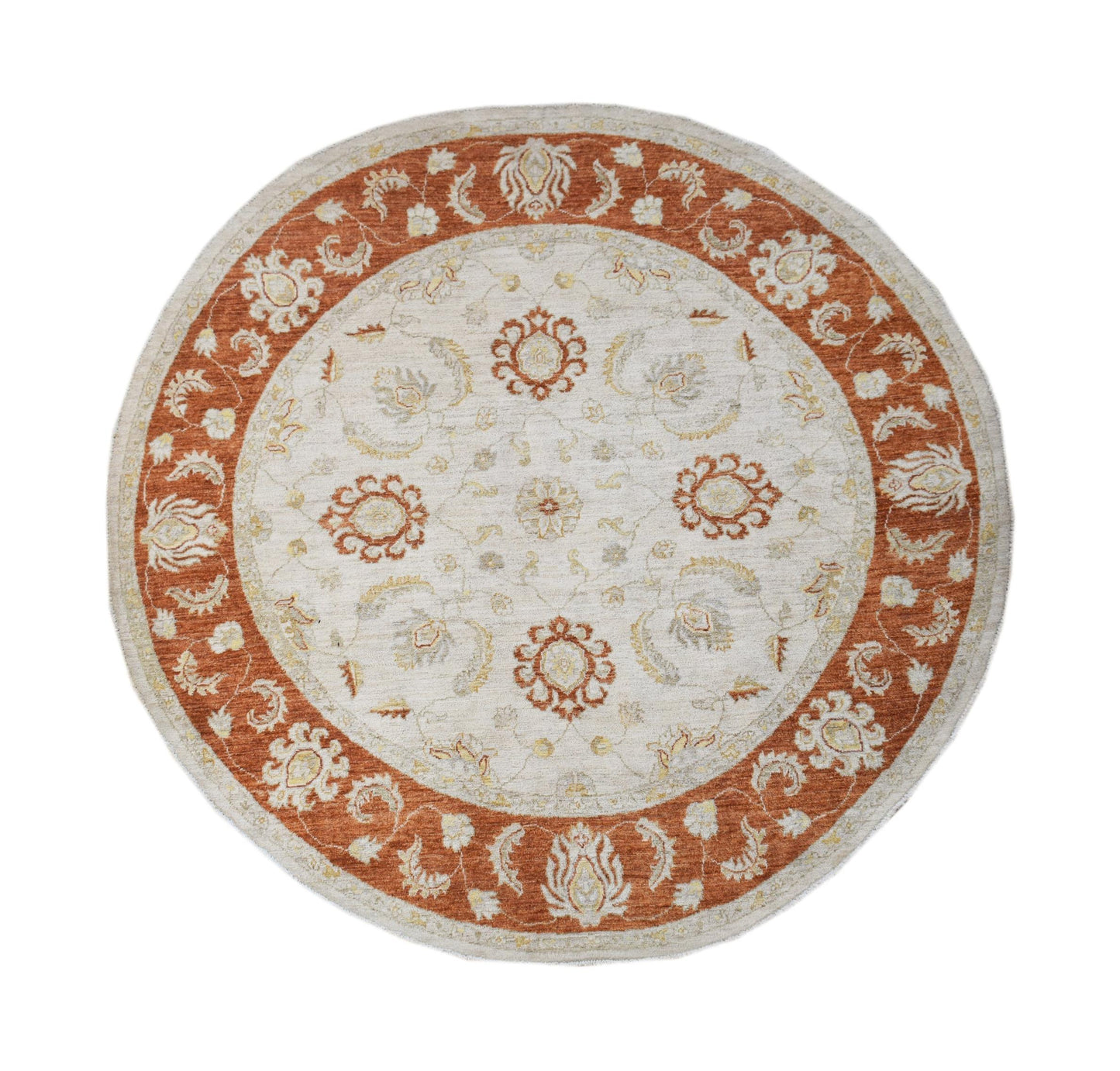A round Afghan Chobi rug featuring a cream center with rust-colored floral patterns and borders.