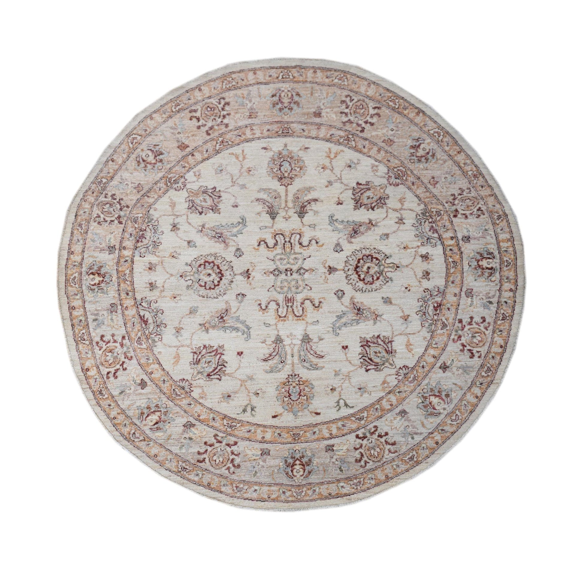 A round Afghan Chobi rug featuring a traditional floral pattern in soft, earthy tones.