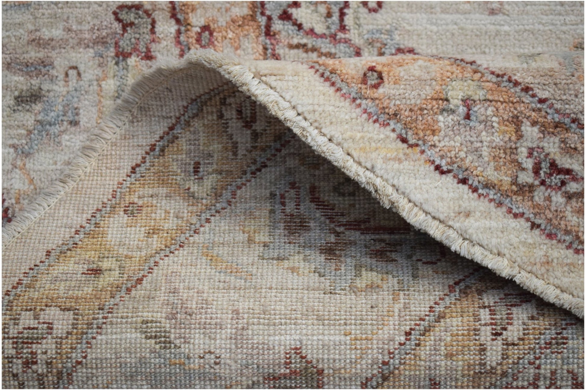 A close-up view of a handwoven Afghan Chobi rug showing its wool texture and traditional pattern.