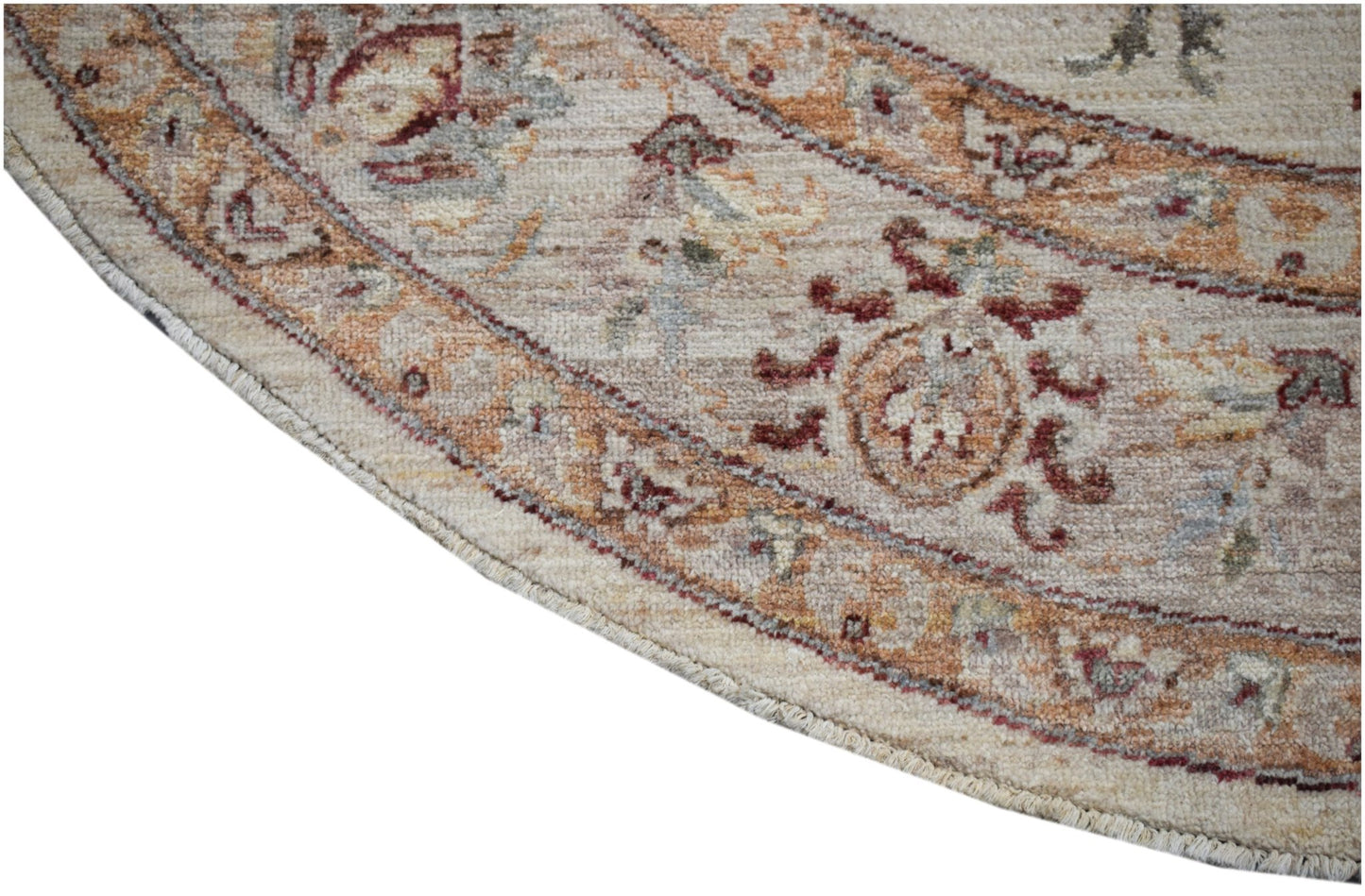 A round Afghan Chobi rug featuring traditional floral patterns in earthy wood tones.