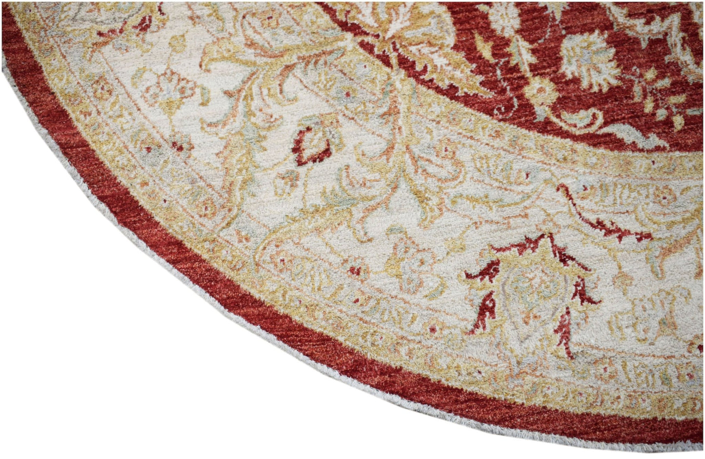 A round Afghan Chobi rug featuring intricate floral patterns in red, cream, and soft gold tones.