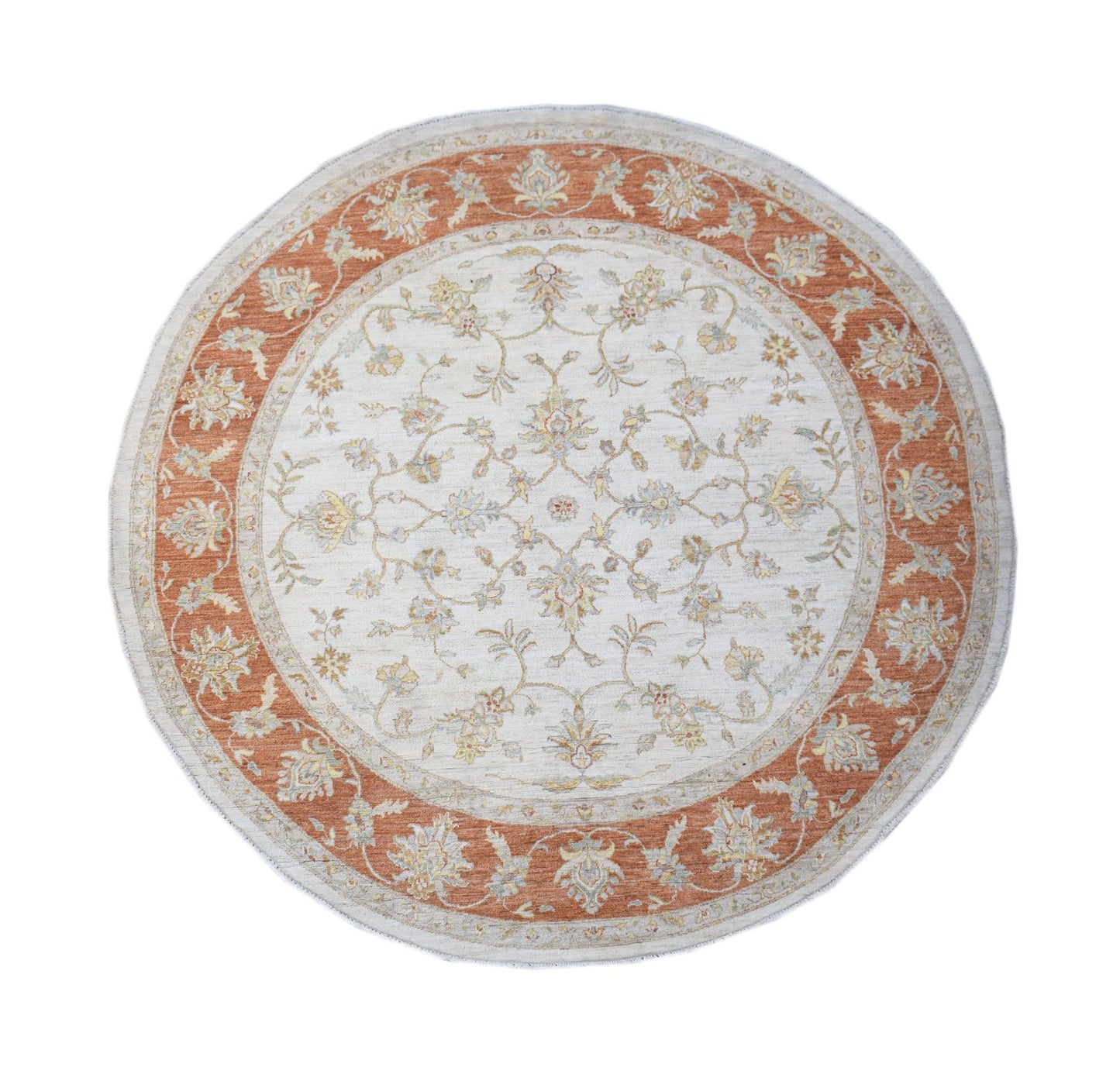 A round Afghan Chobi rug featuring a floral pattern in terracotta and cream tones.