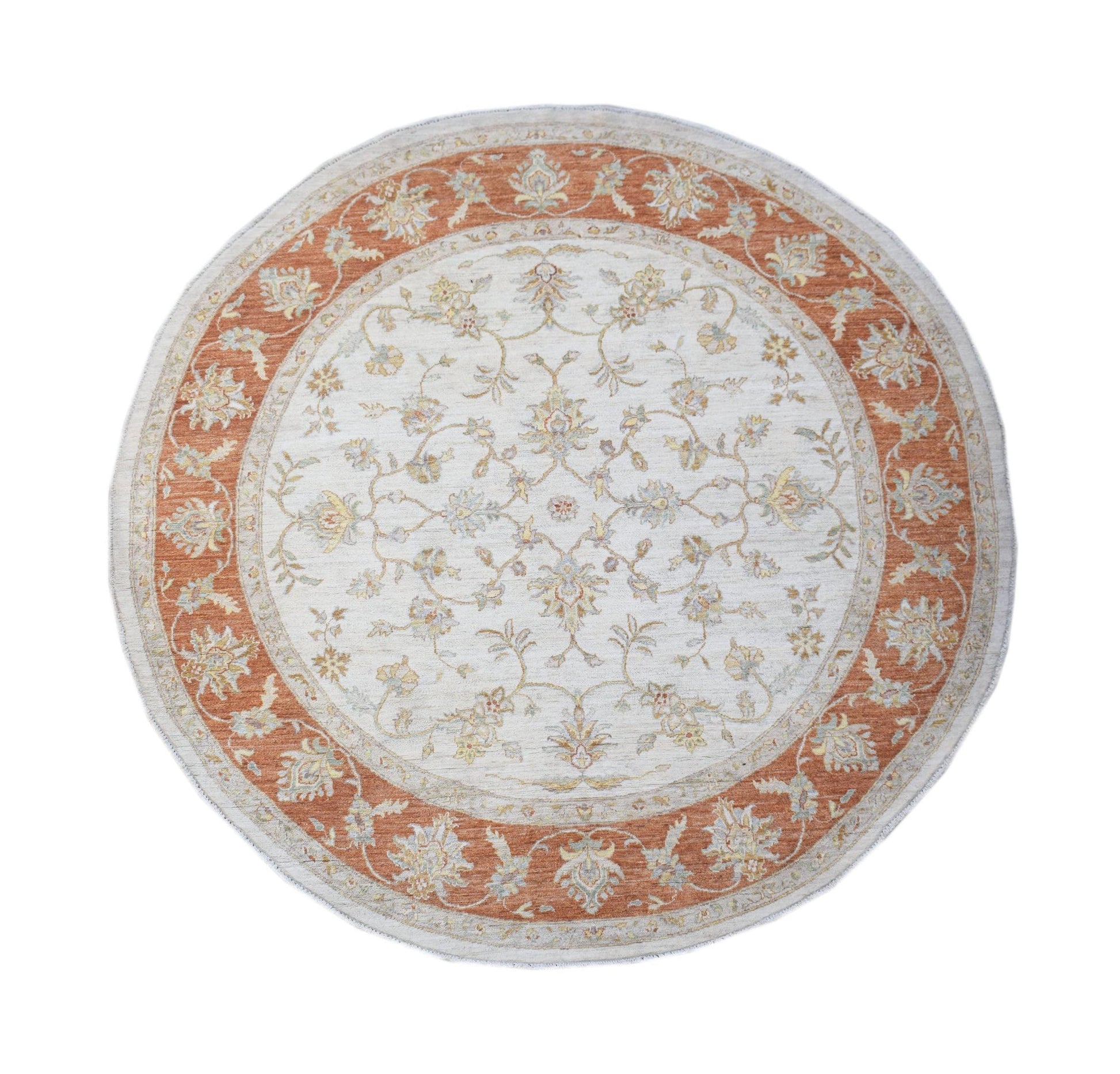 A round Afghan Chobi rug featuring a floral pattern in terracotta and cream tones.