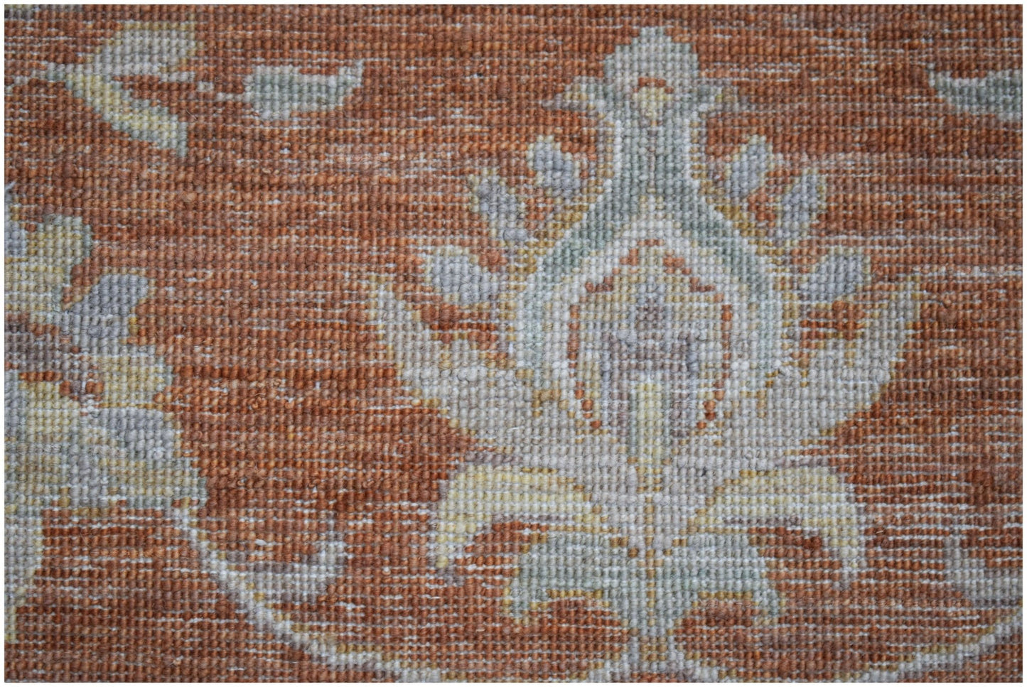 A close-up of an Afghan Chobi rug featuring a traditional floral pattern in earthy tones.