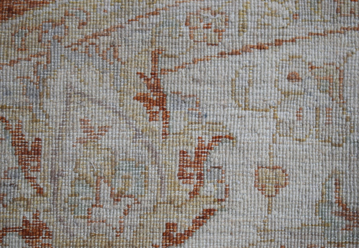 A close-up of a handwoven Afghan Chobi rug featuring traditional patterns in earthy wood tones.