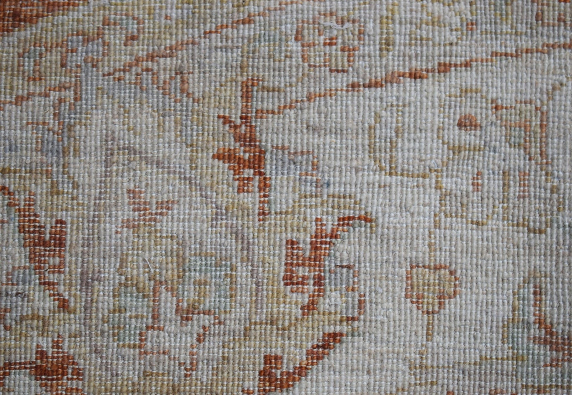 A close-up of a handwoven Afghan Chobi rug featuring traditional patterns in earthy wood tones.