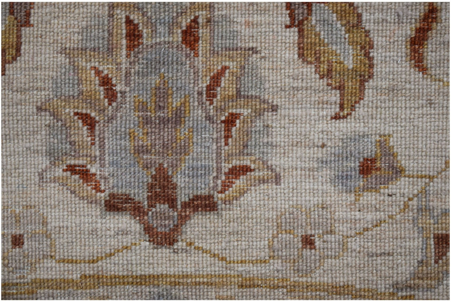 A close-up of a handwoven Afghan Chobi rug featuring traditional floral motifs in earthy tones.