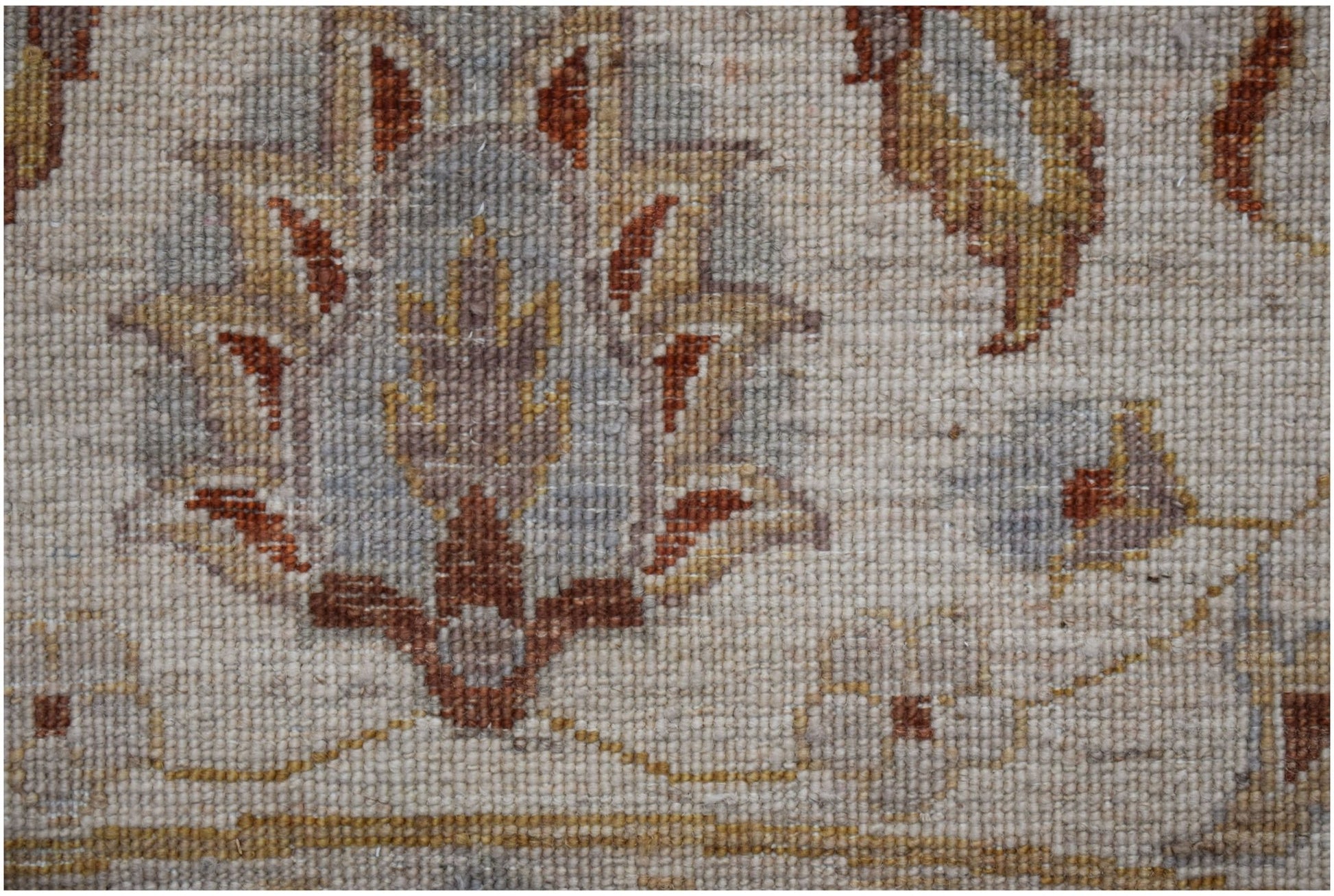 A close-up of a handwoven Afghan Chobi rug featuring traditional floral motifs in earthy tones.