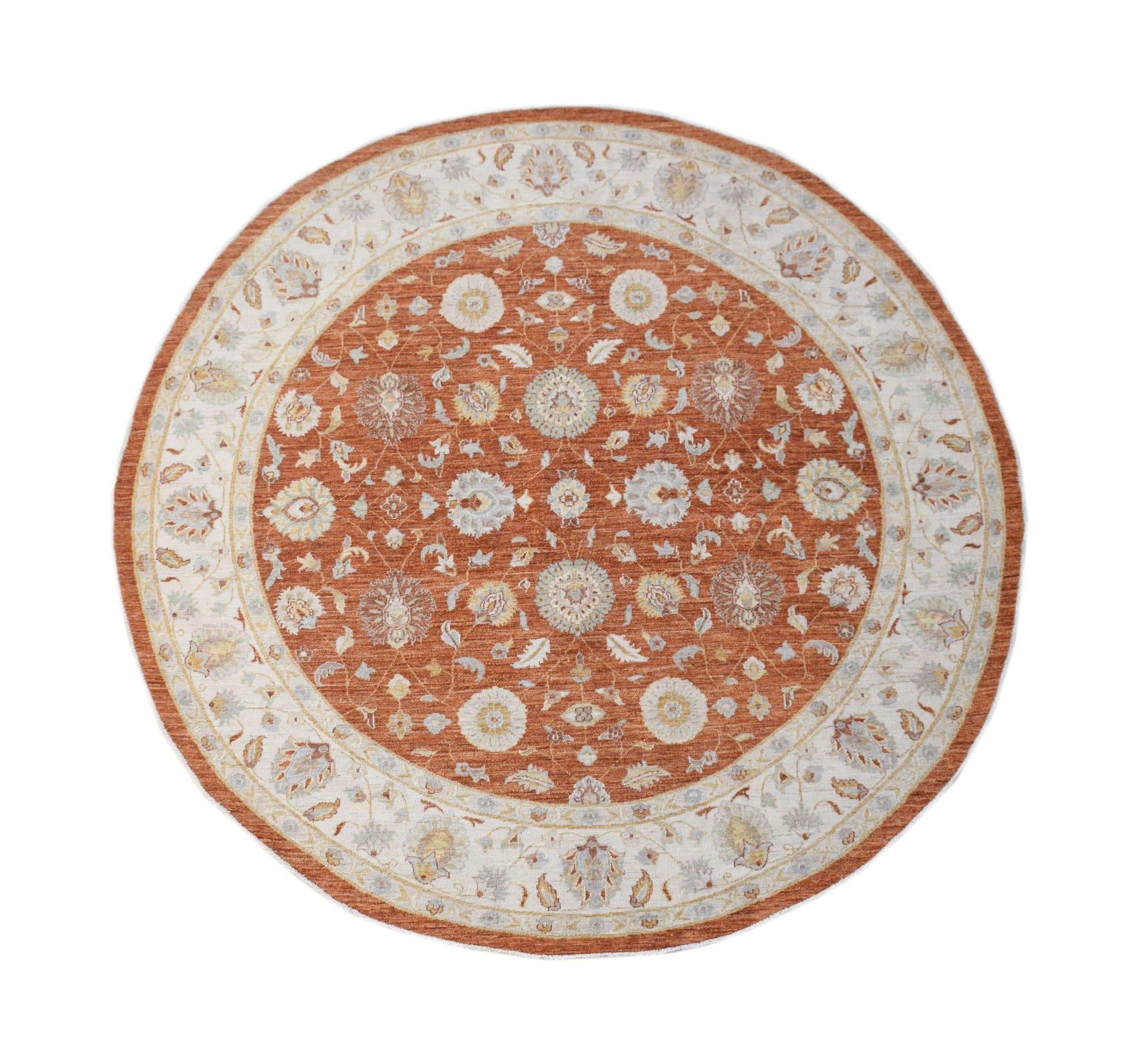 A round Afghan Chobi rug featuring a traditional floral pattern in shades of rust and cream.
