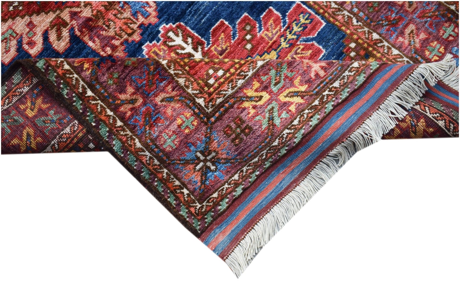 A handwoven Afghan Herati runner featuring intricate traditional patterns in blue and red wool.