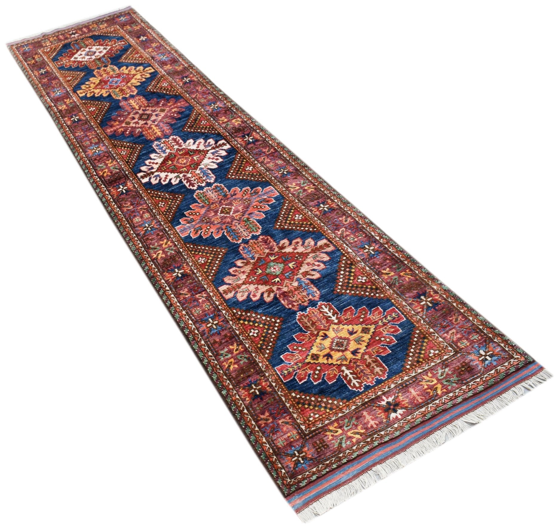 A handwoven Afghan Herati runner rug featuring a blue field with repeating geometric floral motifs.