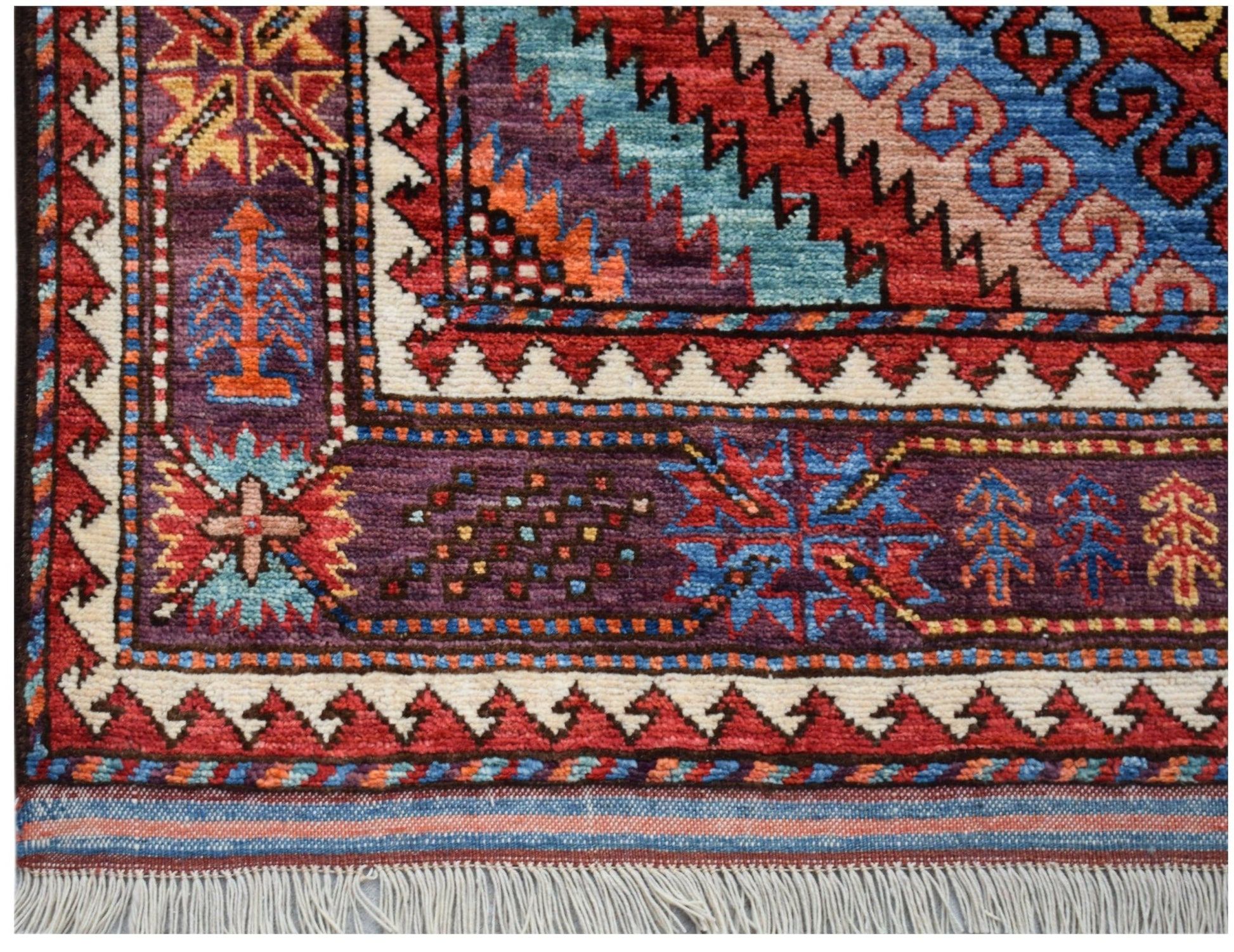 A handwoven Afghan Herati rug featuring intricate geometric patterns in vibrant wool colors.