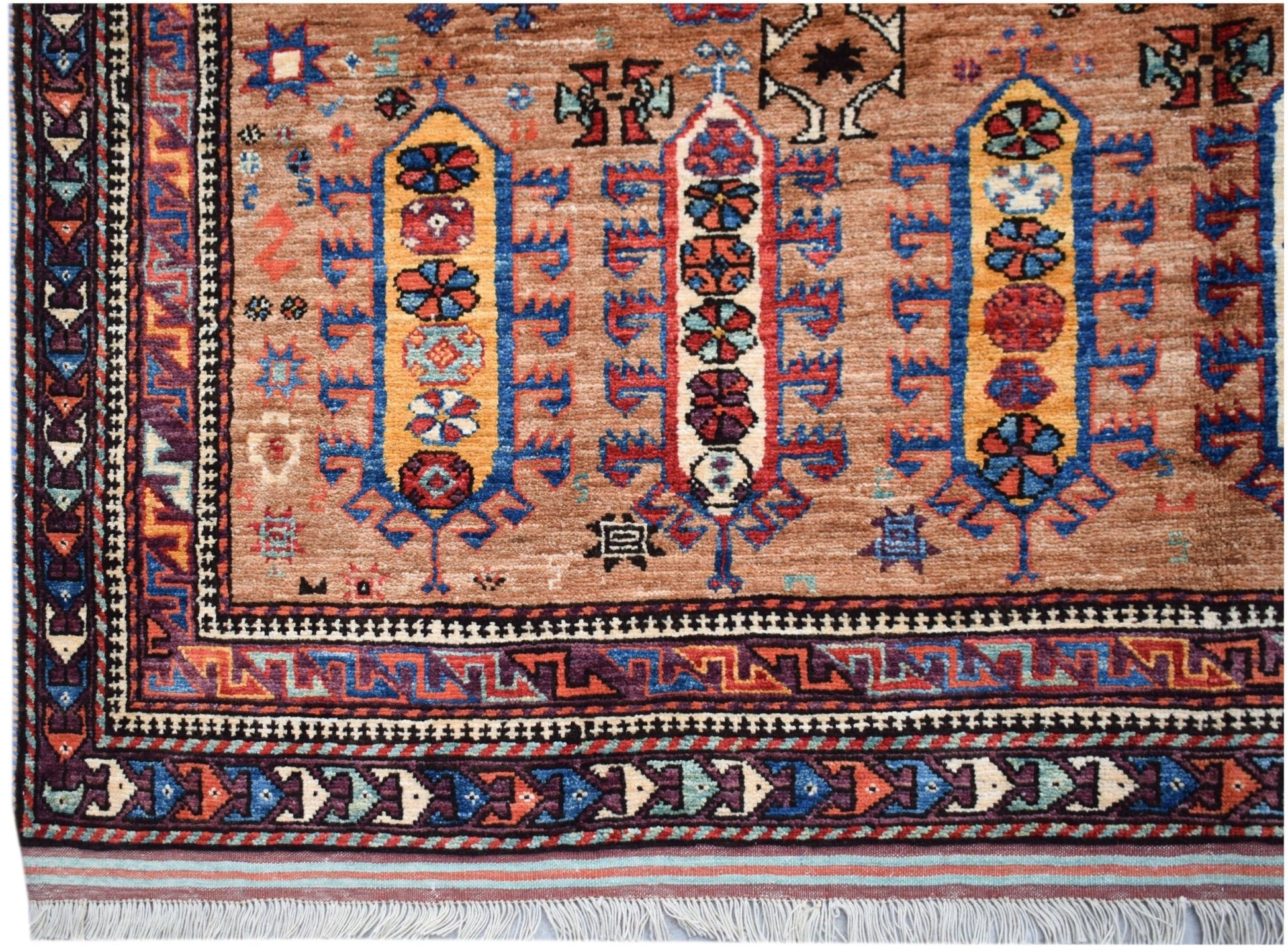 Handwoven Afghan Herati rug featuring traditional geometric patterns in warm earth tones.