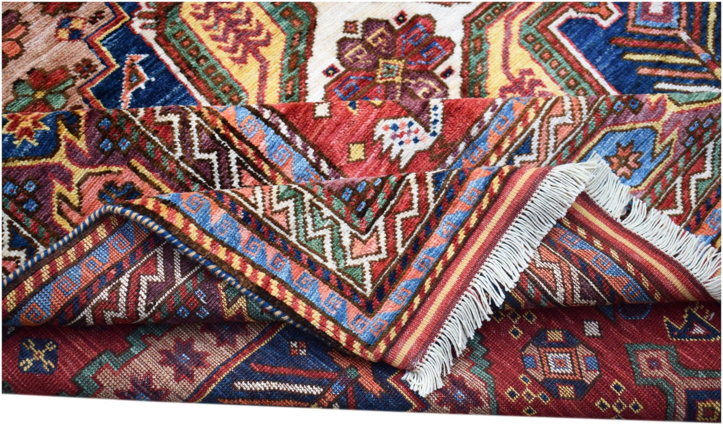A handwoven Afghan Herati rug featuring intricate geometric patterns in vibrant red and blue tones.