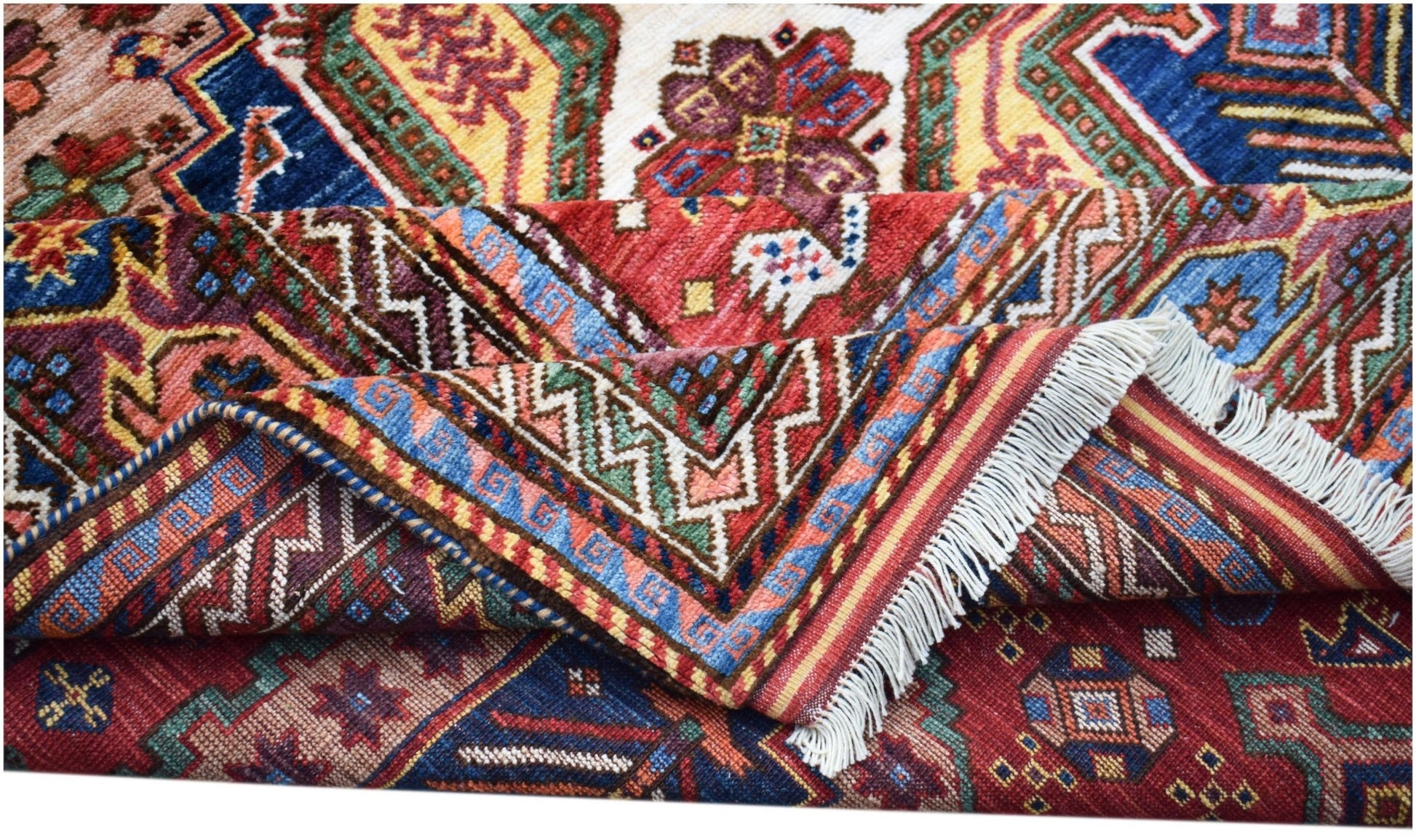 A handwoven Afghan Herati rug featuring intricate geometric patterns in vibrant red and blue tones.