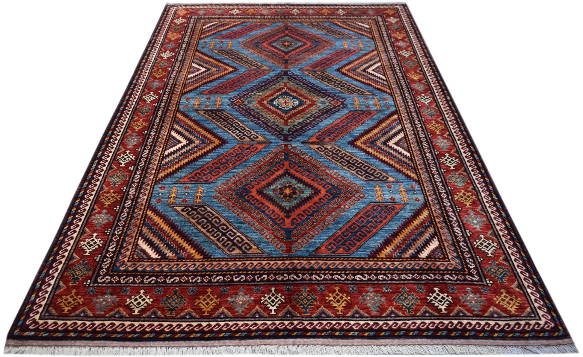 A rectangular Afghan Herati rug featuring a blue field with geometric diamond patterns and red borders.