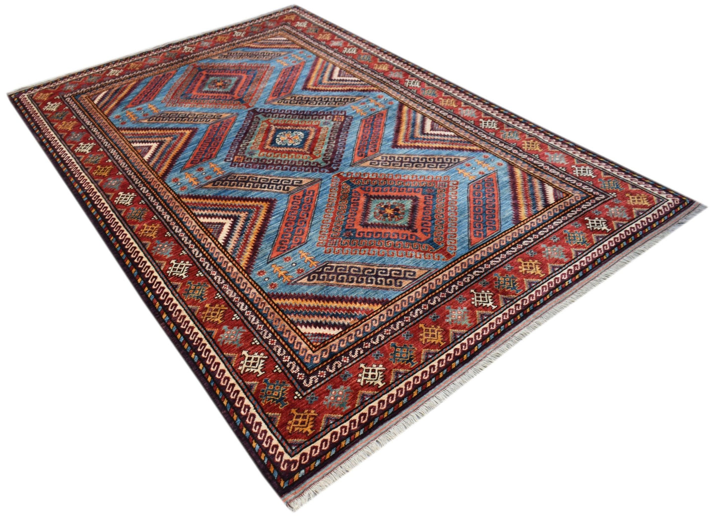 A rectangular Afghan Herati rug featuring a geometric diamond pattern in blue and red tones.