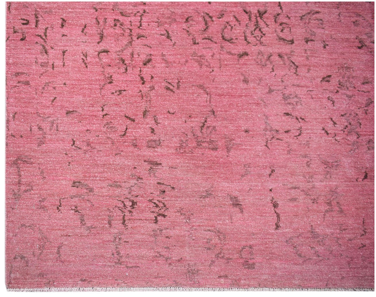 An overdyed Afghan Chobi rug featuring a distressed pink field with subtle dark brown patterns.