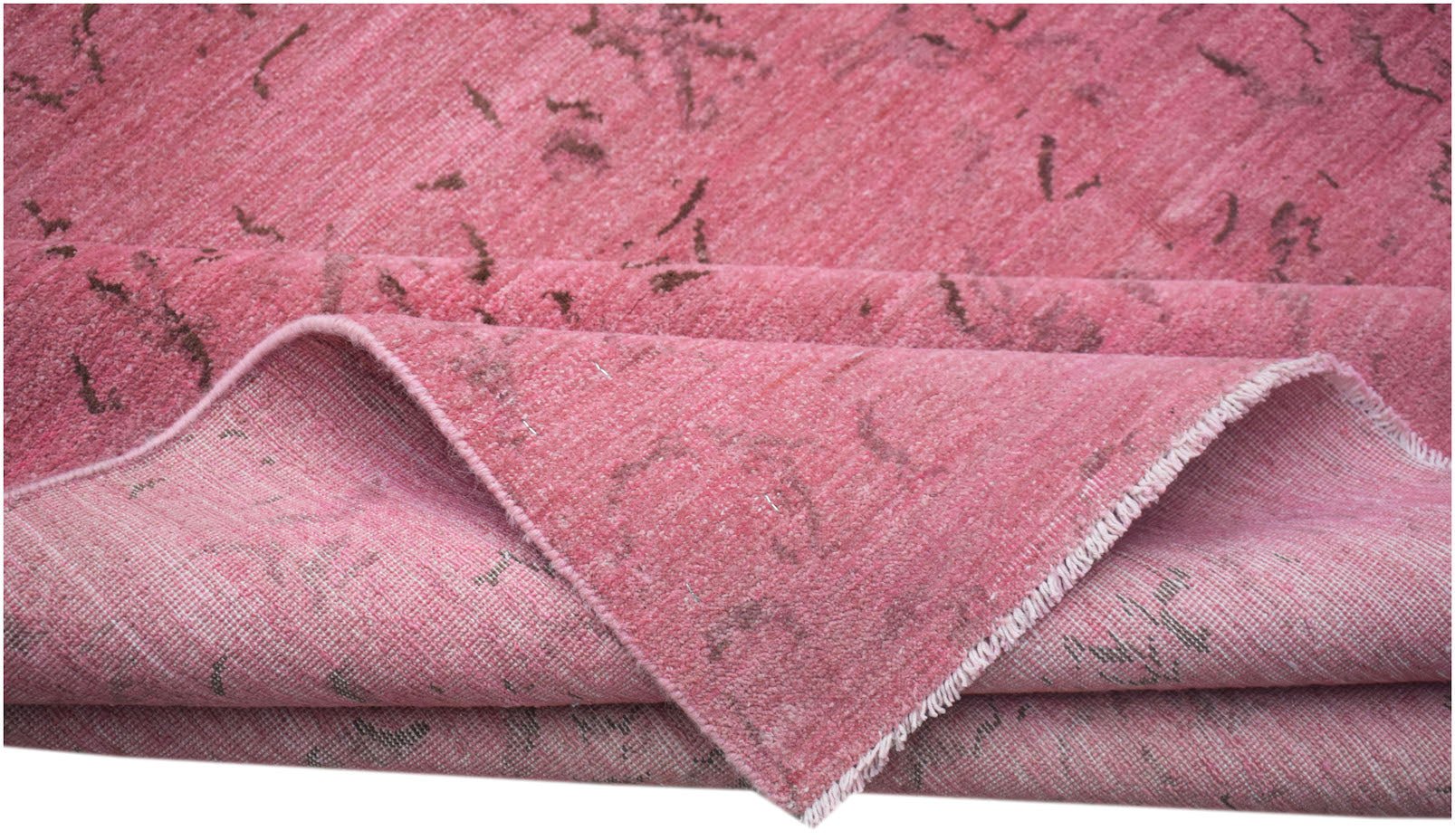 A handmade Afghan Chobi rug featuring an overdyed pink finish with subtle dark patterned accents.