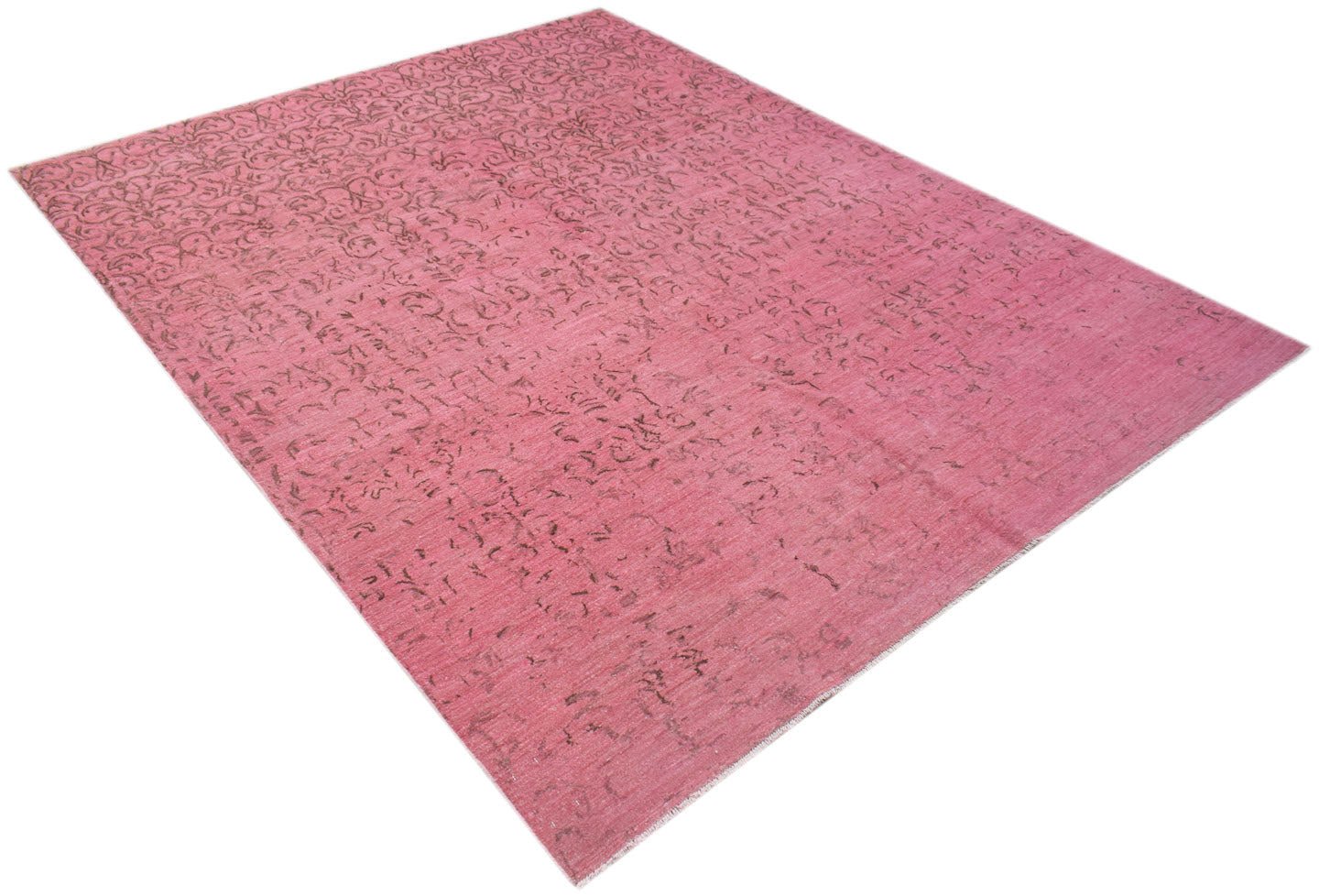 An overdyed Afghan Chobi rug featuring a faded floral pattern in shades of pink.