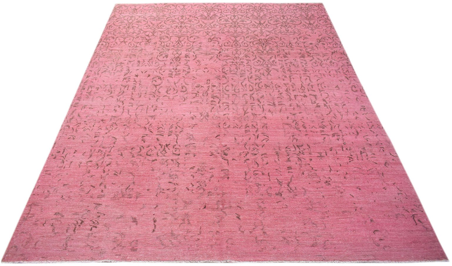 A rectangular, handwoven Afghan Chobi rug featuring a distressed, overdyed pink floral pattern.