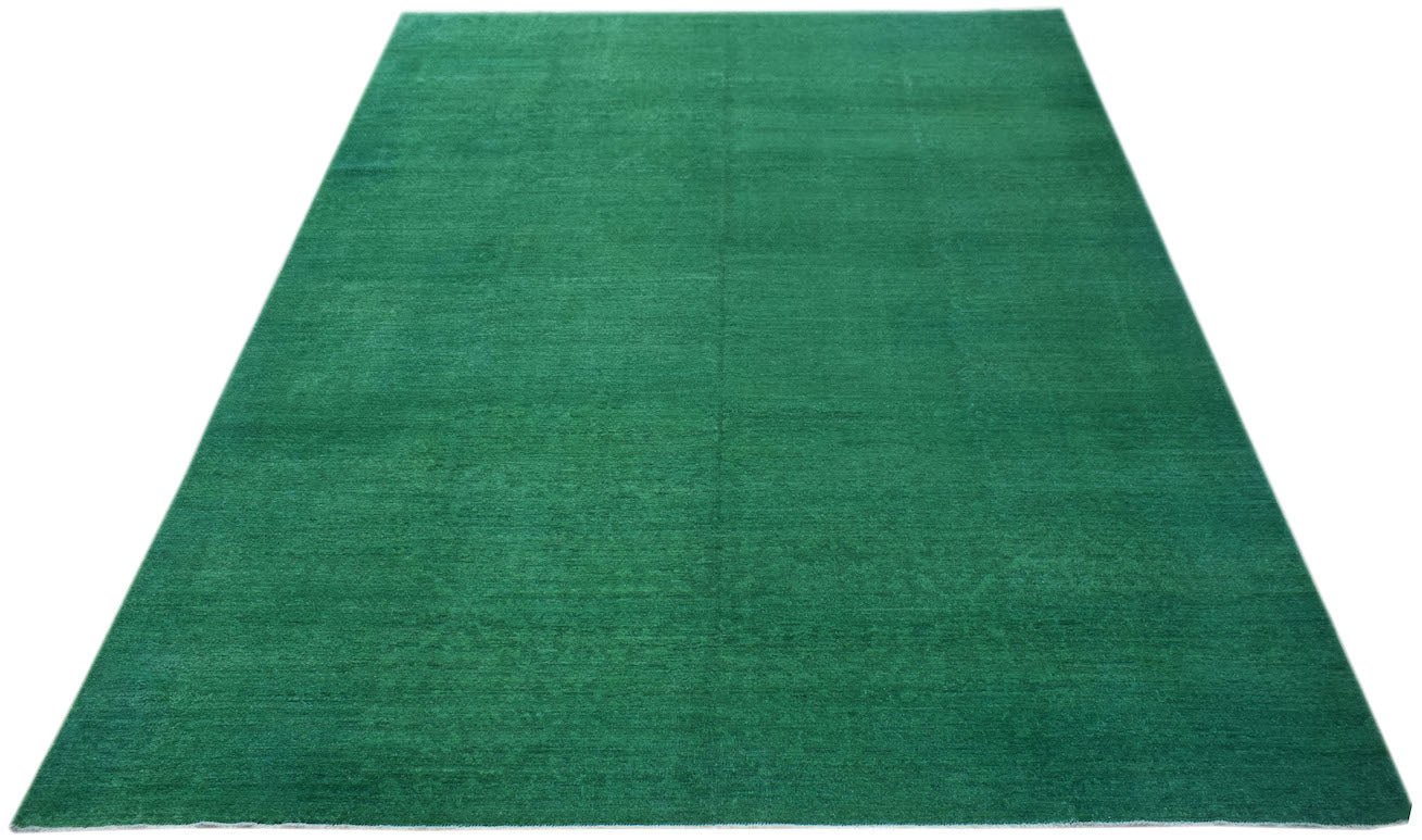 A rectangular, handwoven Afghan Chobi rug featuring a solid, vibrant green overdyed finish.