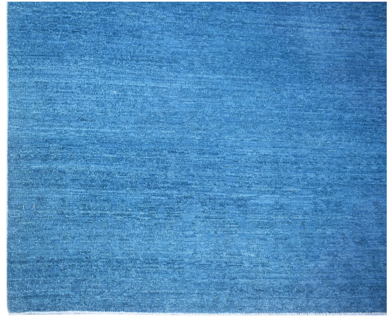 A handwoven Afghan Chobi rug featuring a solid, textured blue wool surface.