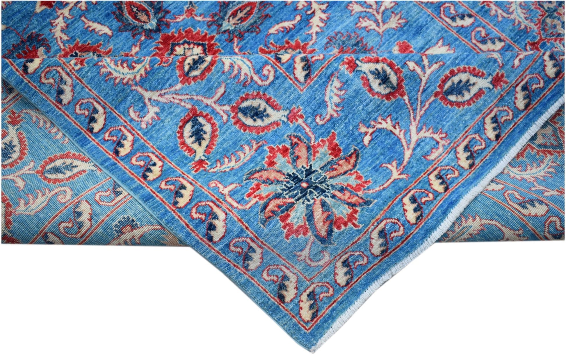 A handmade Afghan Chobi rug featuring a blue field with red and cream floral Suzani motifs.