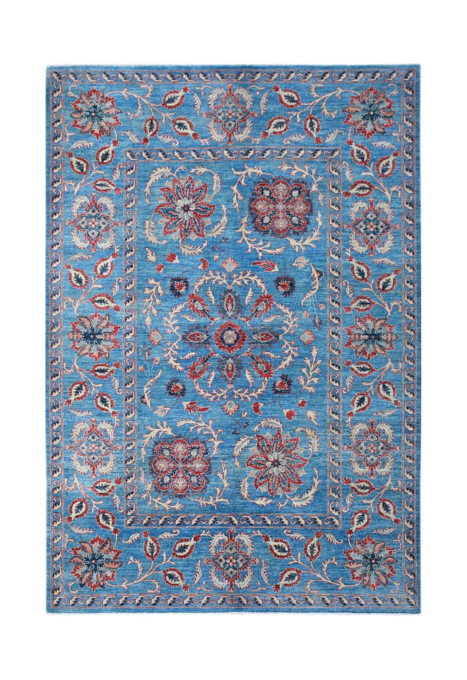 Handwoven Afghan Chobi rug featuring a blue field with traditional red and cream floral motifs.