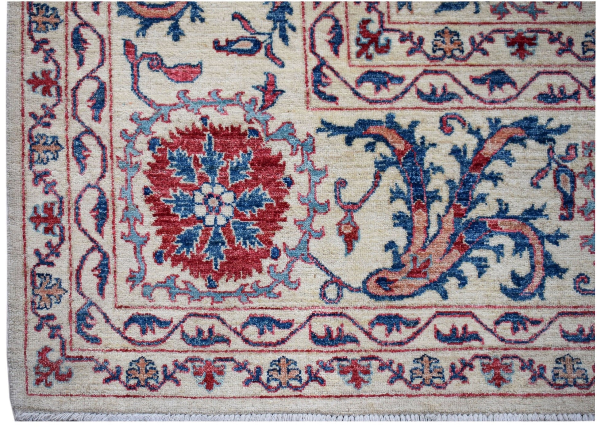 Handwoven Afghan Chobi rug featuring traditional Suzani floral motifs in red and blue on cream.
