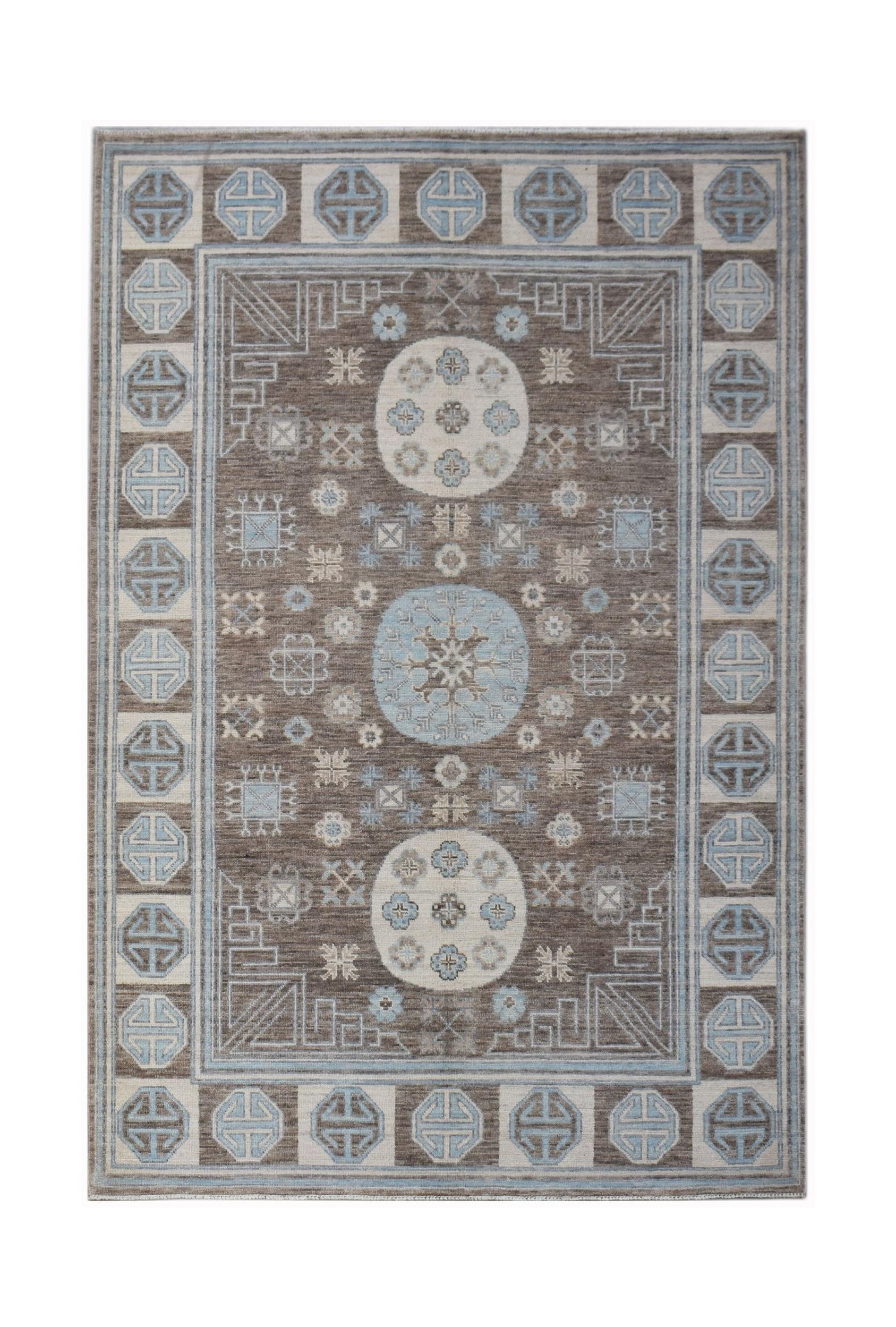 A rectangular transitional Oushak rug featuring a brown field with blue geometric medallions.