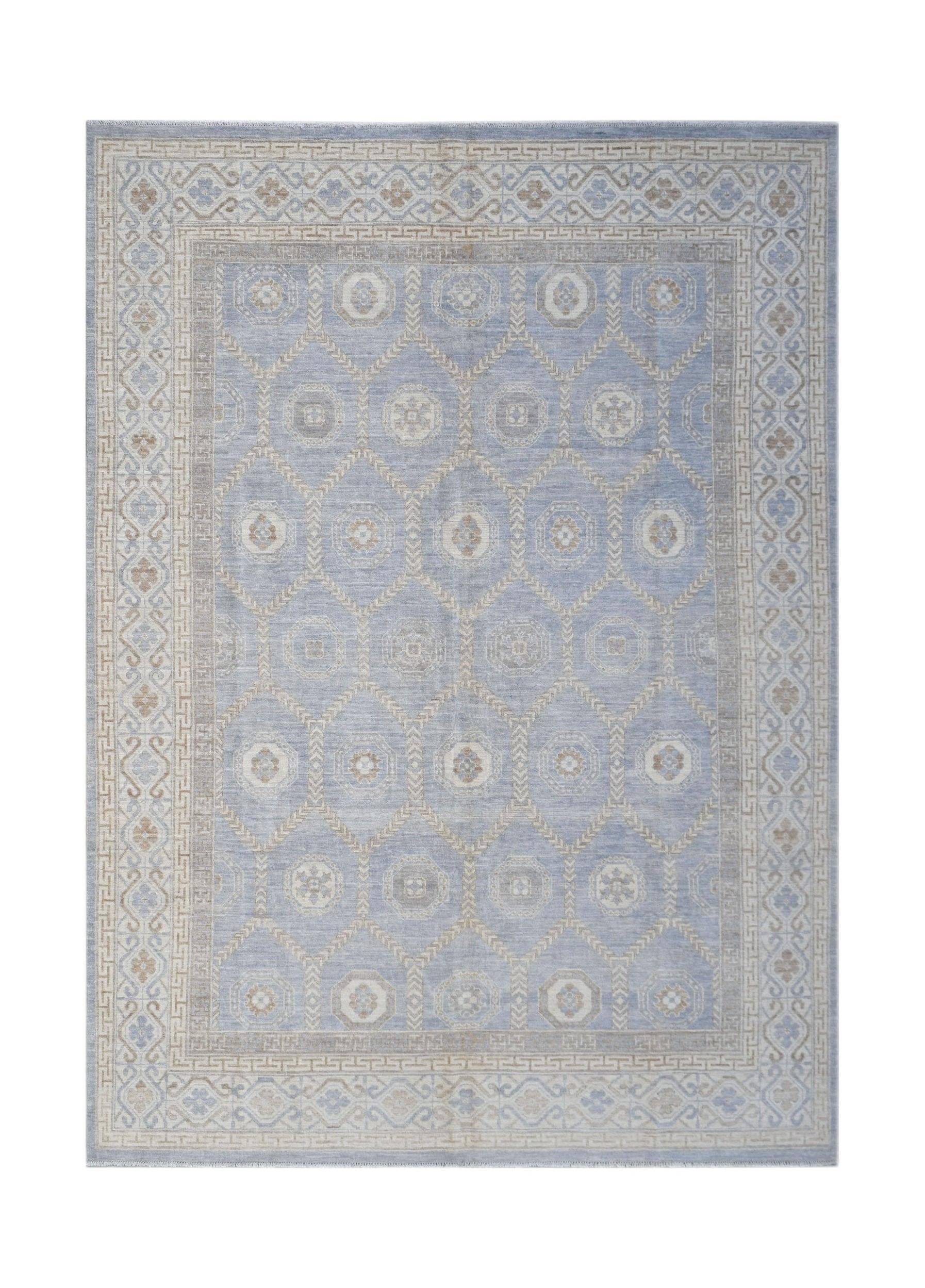 A handmade wool Oushak rug featuring a light blue field with a geometric Khotan medallion pattern.
