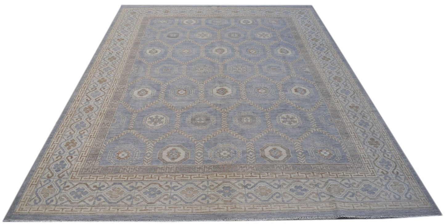 A handmade wool Oushak rug featuring a blue field with a repeating geometric Khotan pattern.