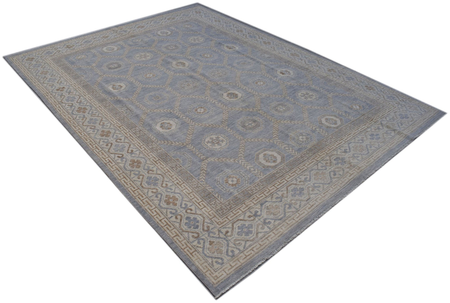 A handmade transitional Oushak rug featuring a blue field with a geometric Khotan pattern.