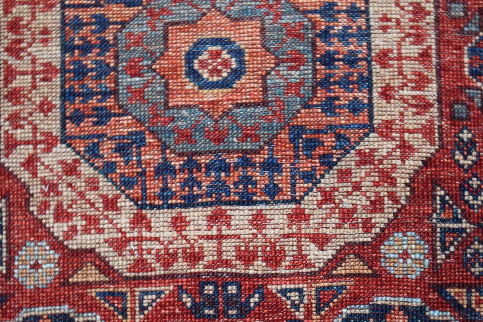 A close-up of a handwoven Afghan Chobi runner featuring a detailed geometric Mamluk medallion.