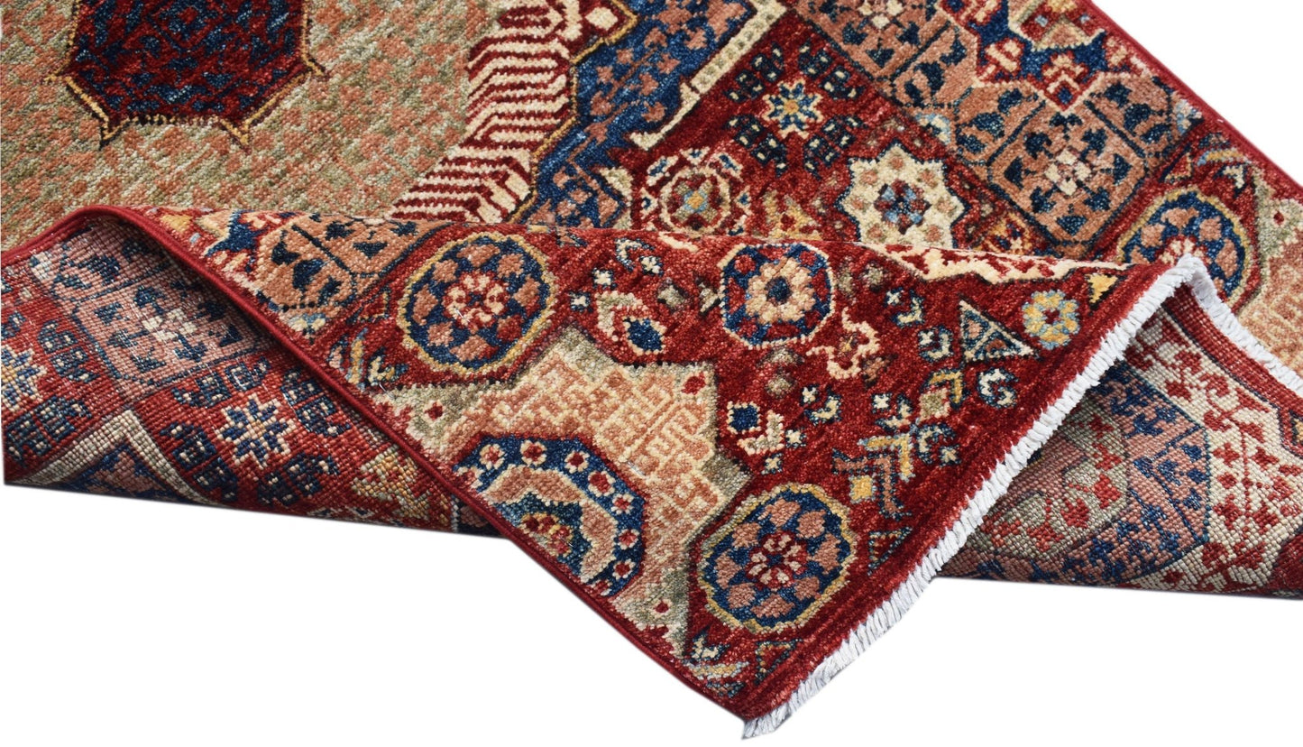 A handmade Afghan Chobi runner featuring a traditional red and blue Mamluk medallion pattern.