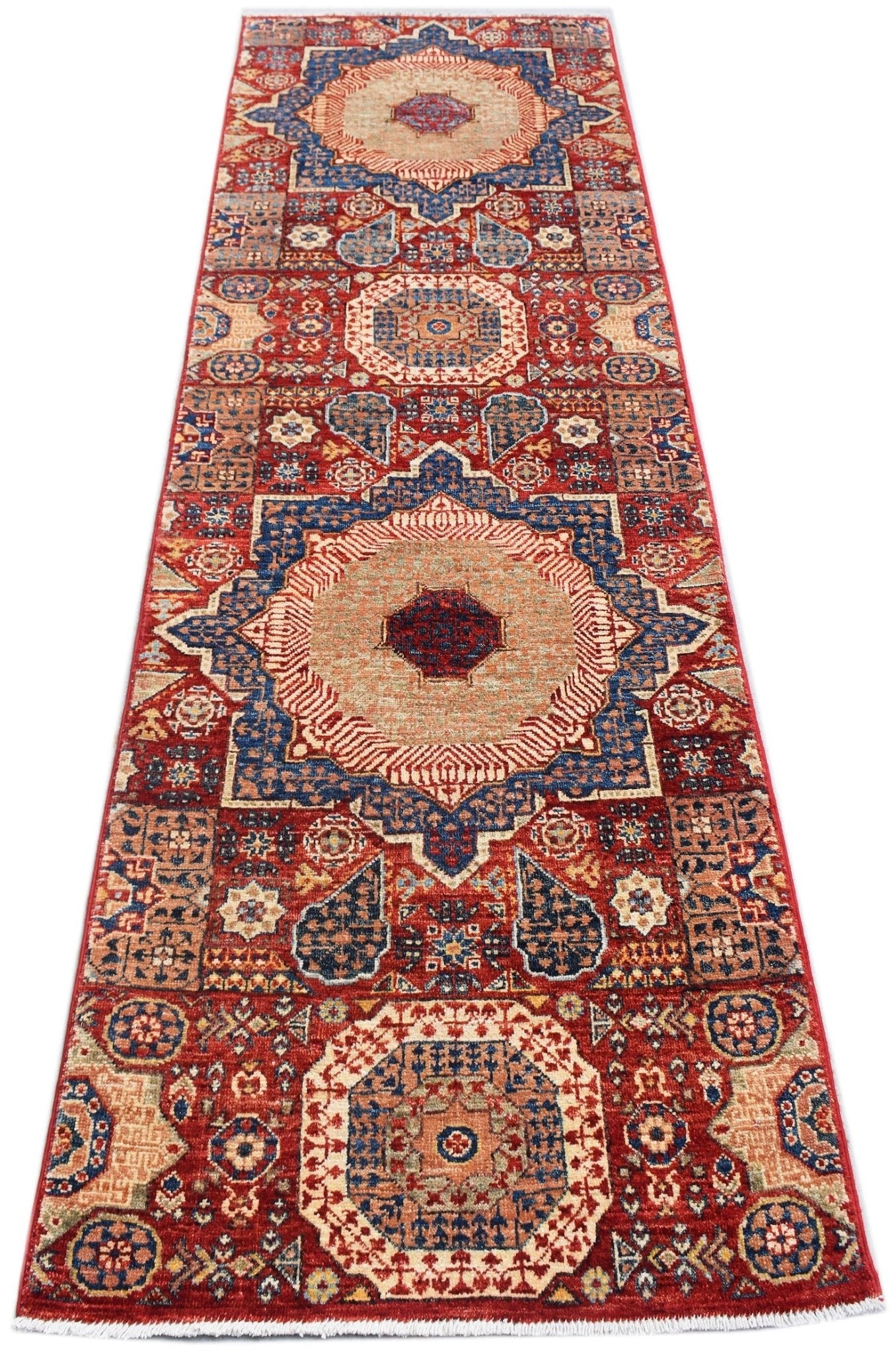 A handmade Afghan Chobi runner featuring a traditional Mamluk medallion pattern in red and blue.