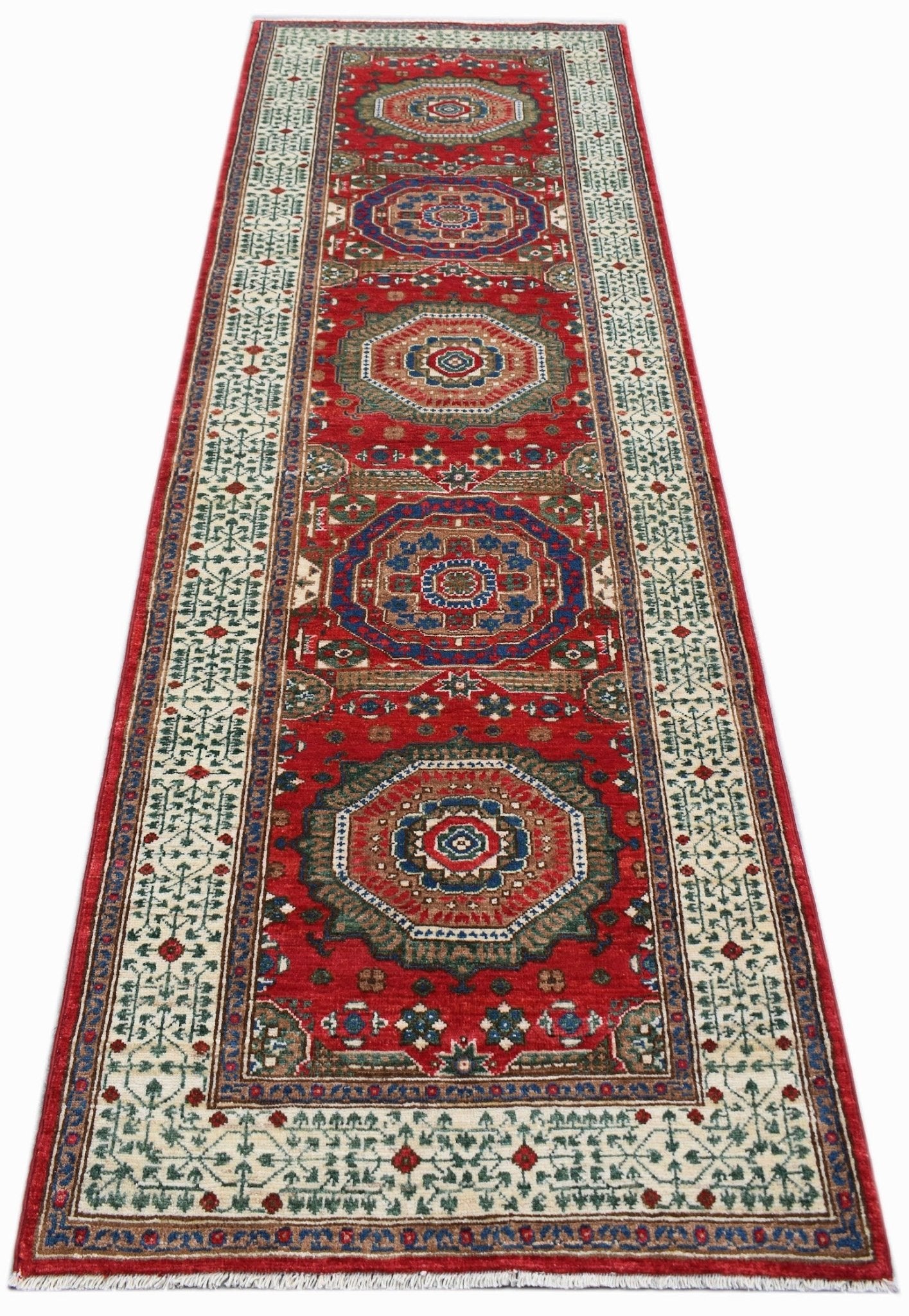 A handmade Afghan Chobi runner rug featuring a red field with repeating Mamluk medallions.
