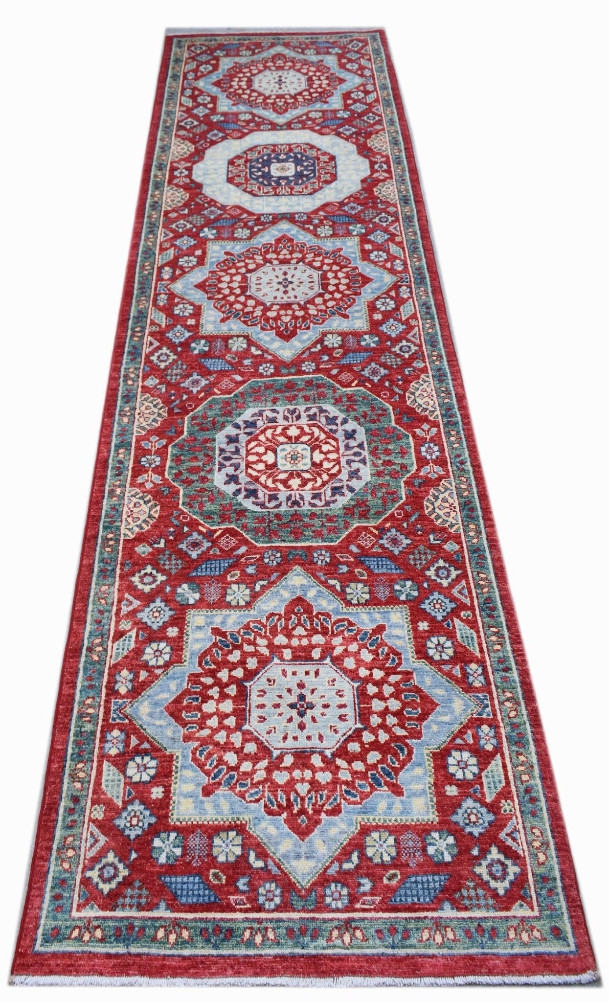A handmade Afghan Chobi runner rug featuring a traditional red and blue Mamluk medallion pattern.