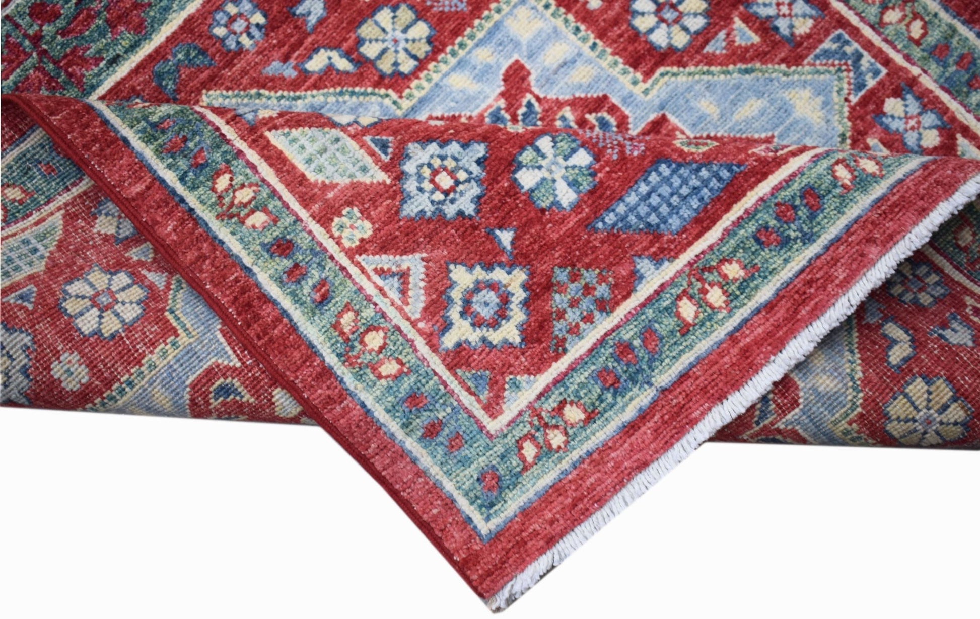 A handwoven Afghan Chobi runner featuring a red field with intricate blue Mamluk medallion patterns.
