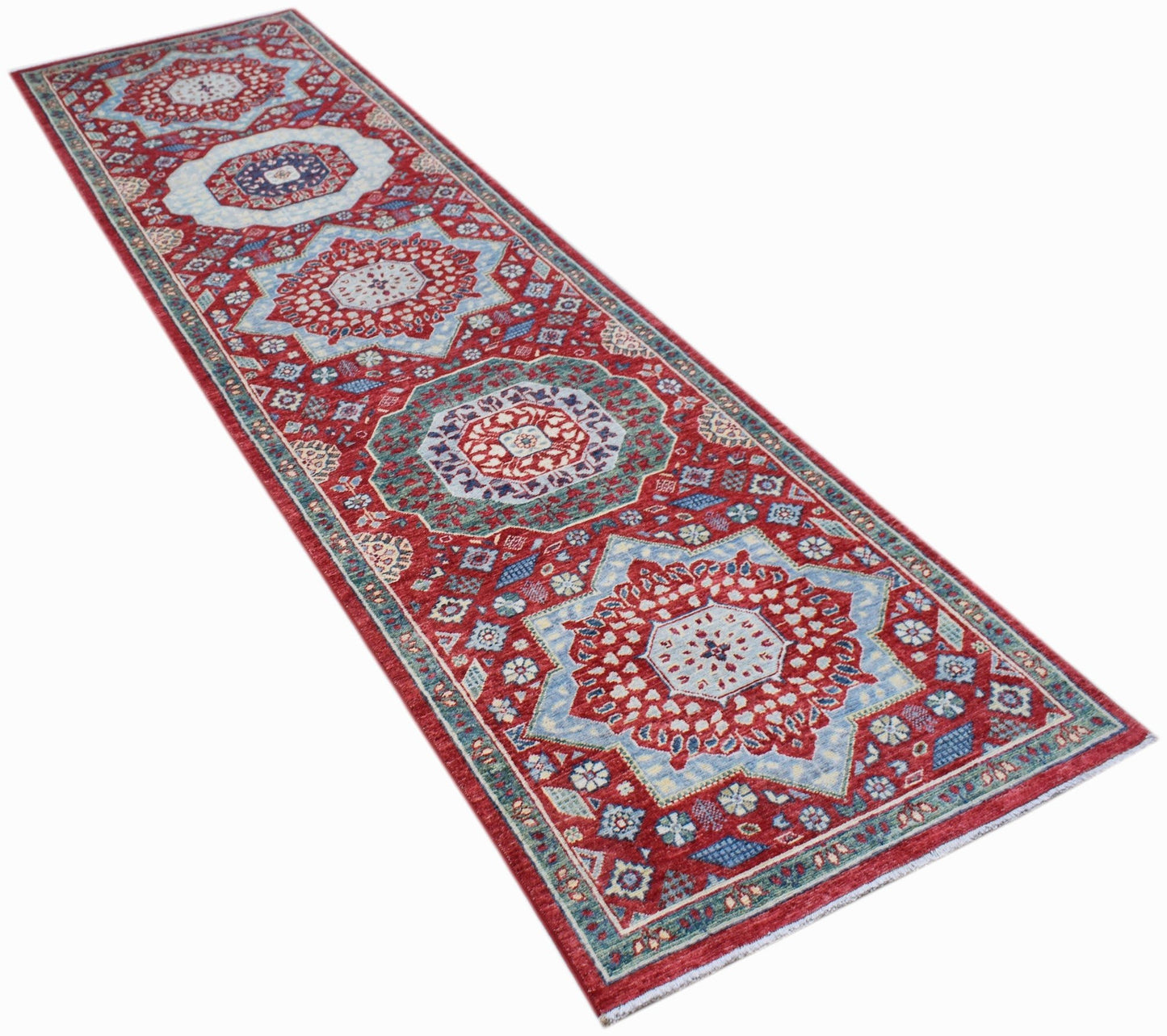 A handmade Afghan Chobi runner rug featuring a traditional red and blue Mamluk medallion pattern.