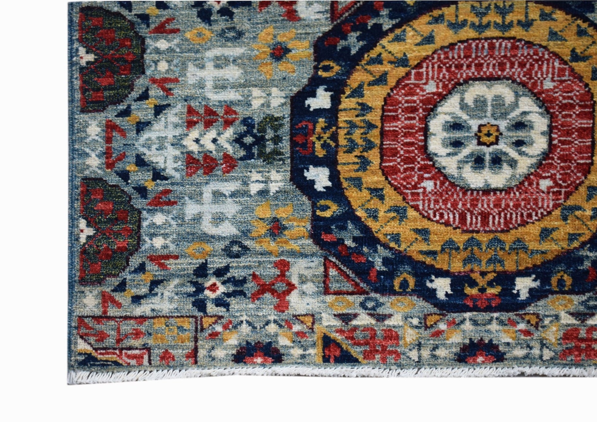 A handmade Afghan Chobi runner featuring a traditional blue, red, and yellow Mamluk medallion.