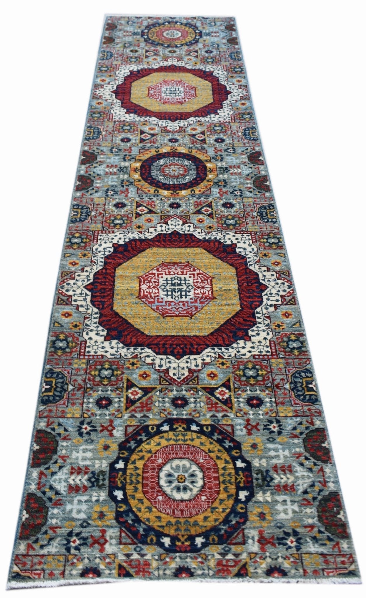 A handmade Afghan Chobi runner rug featuring a traditional Mamluk medallion pattern.