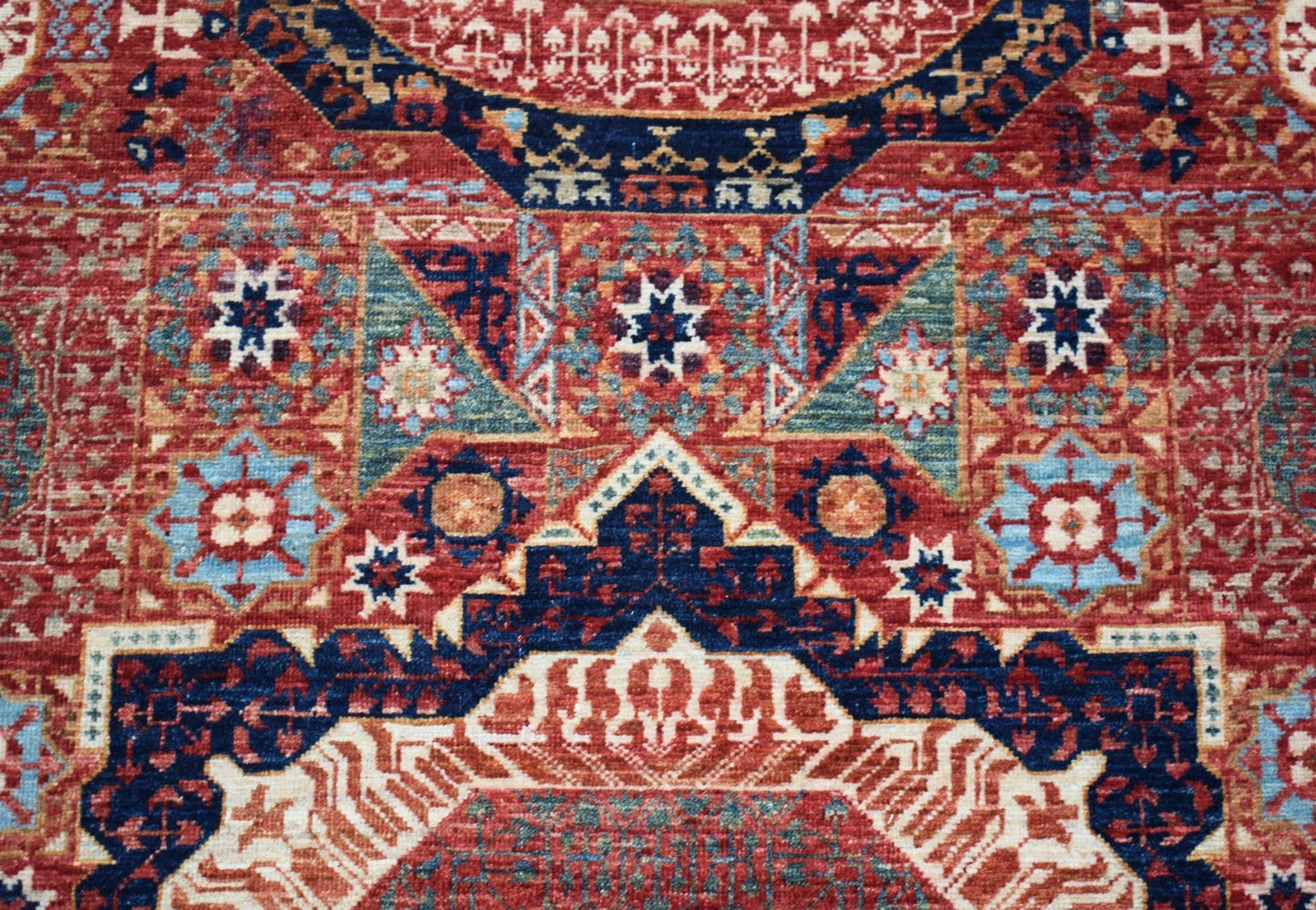 A handwoven Afghan Chobi runner featuring a detailed Mamluk geometric medallion pattern.