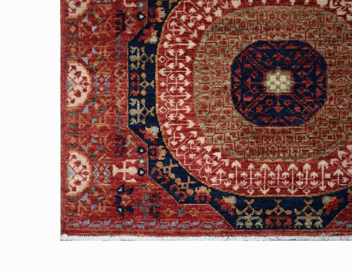 A handmade Afghan Chobi runner featuring a traditional red and blue Mamluk medallion pattern.