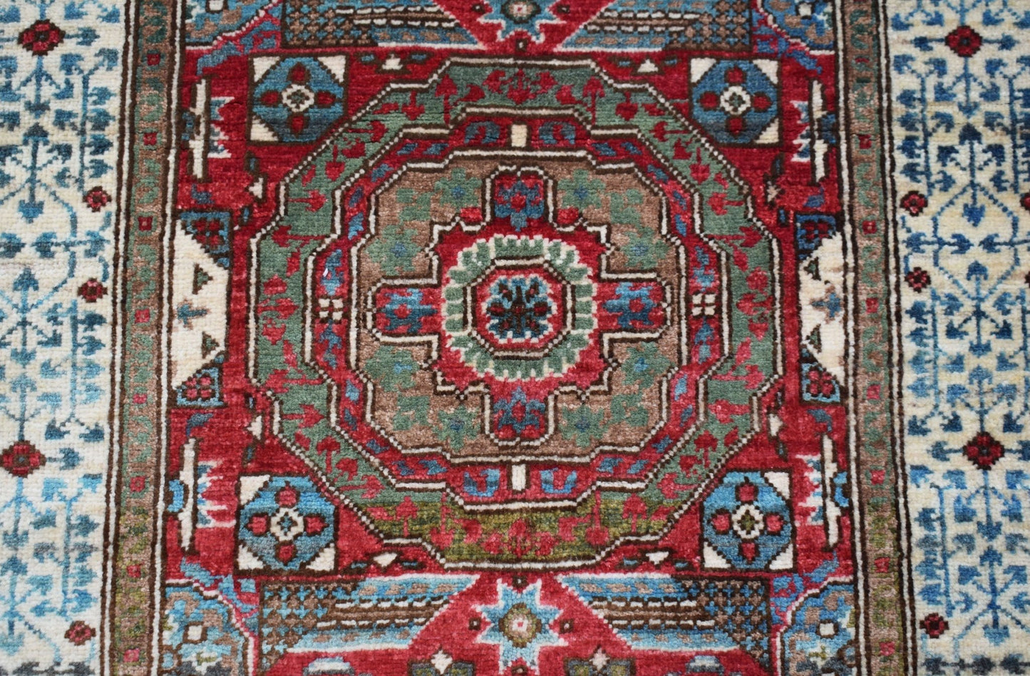A handmade Afghan Chobi runner featuring a detailed Mamluk medallion pattern in red and blue.