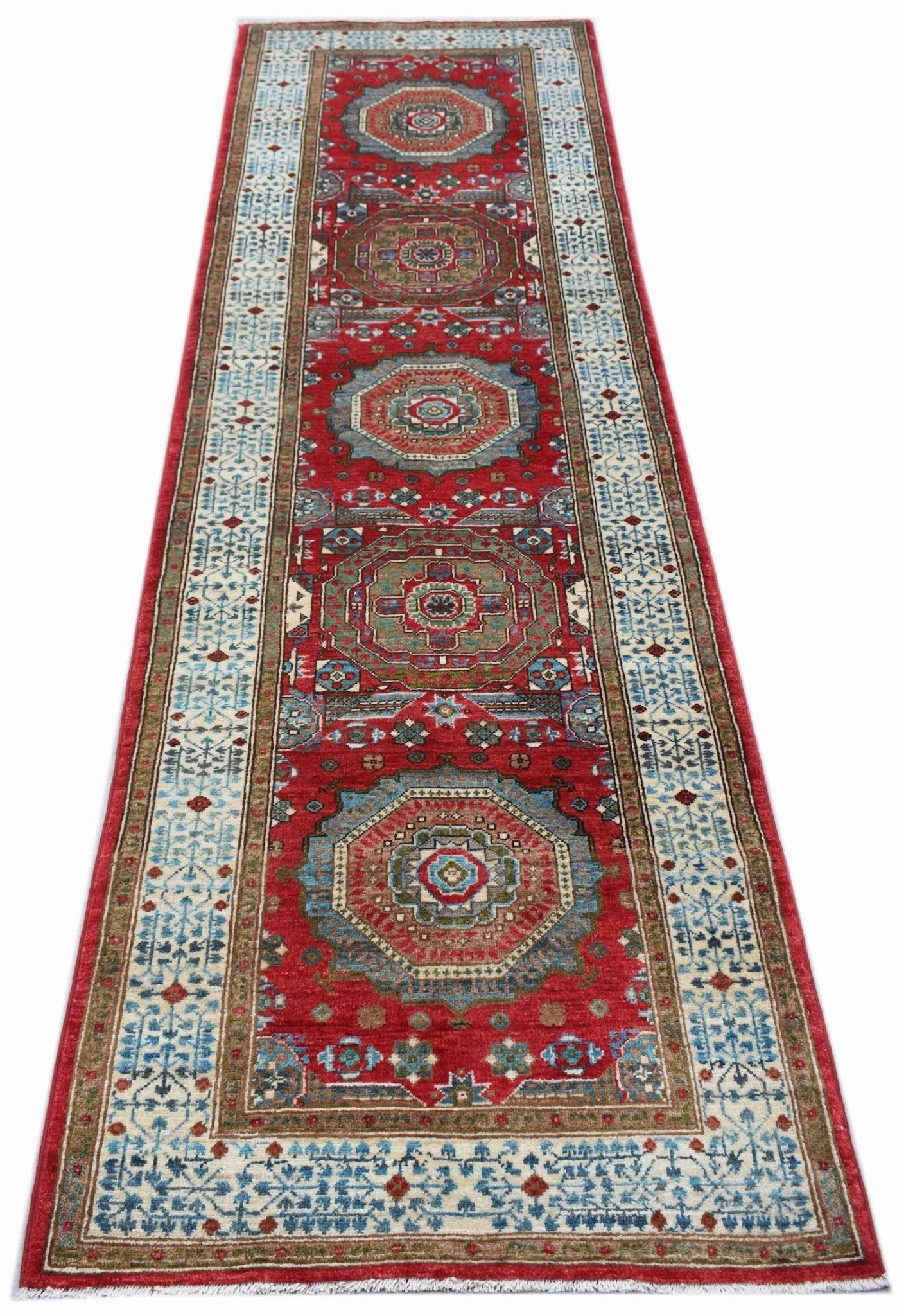 A handmade Afghan Chobi runner rug featuring a red field with repeating Mamluk medallions.