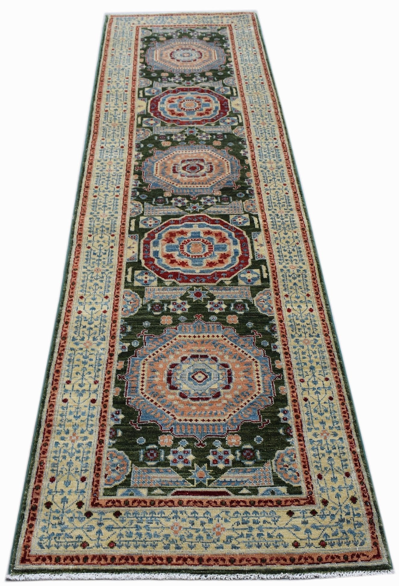 An Afghan Chobi runner rug featuring a dark green field with repeating Mamluk medallion patterns.